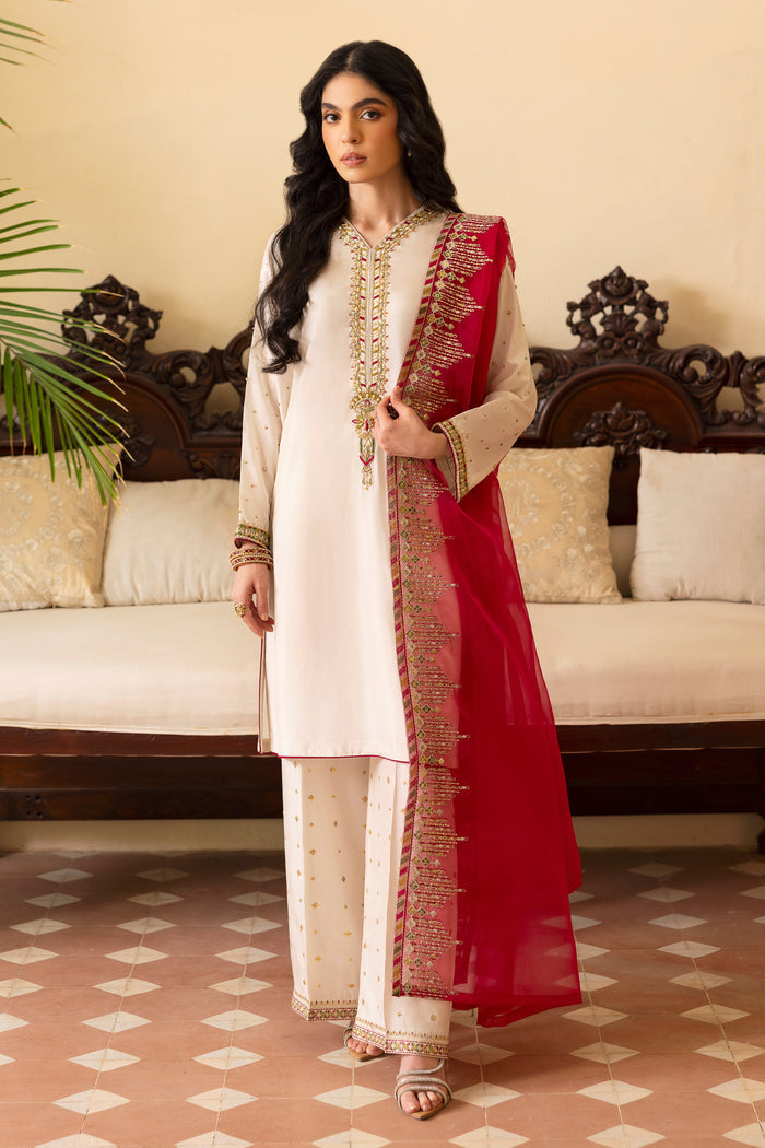 Side view of NAQSHI Abish showcasing fluid straight-cut shirt silhouette, hand-adda spray on sleeves with delicate hot‑pink piping along cuff and sequin-detailed matching culottes.