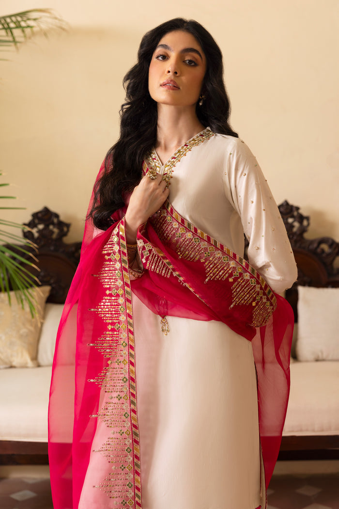 Detailed shot of NAQSHI Abish sleeve cuff showing fine hand-adda embellishments spray, hot‑pink piping finish and subtle thread textures on white raw silk.