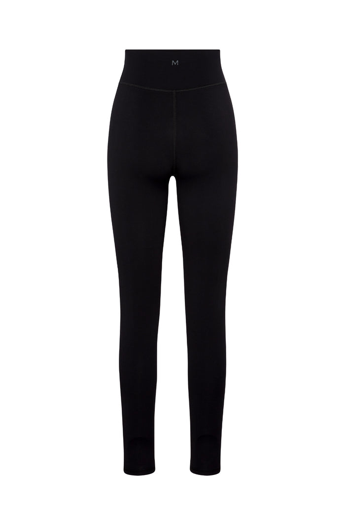 Back view of Acadia 27-inch legging in black showcasing high-rise flat waistband, center back seam and small M logo on white background