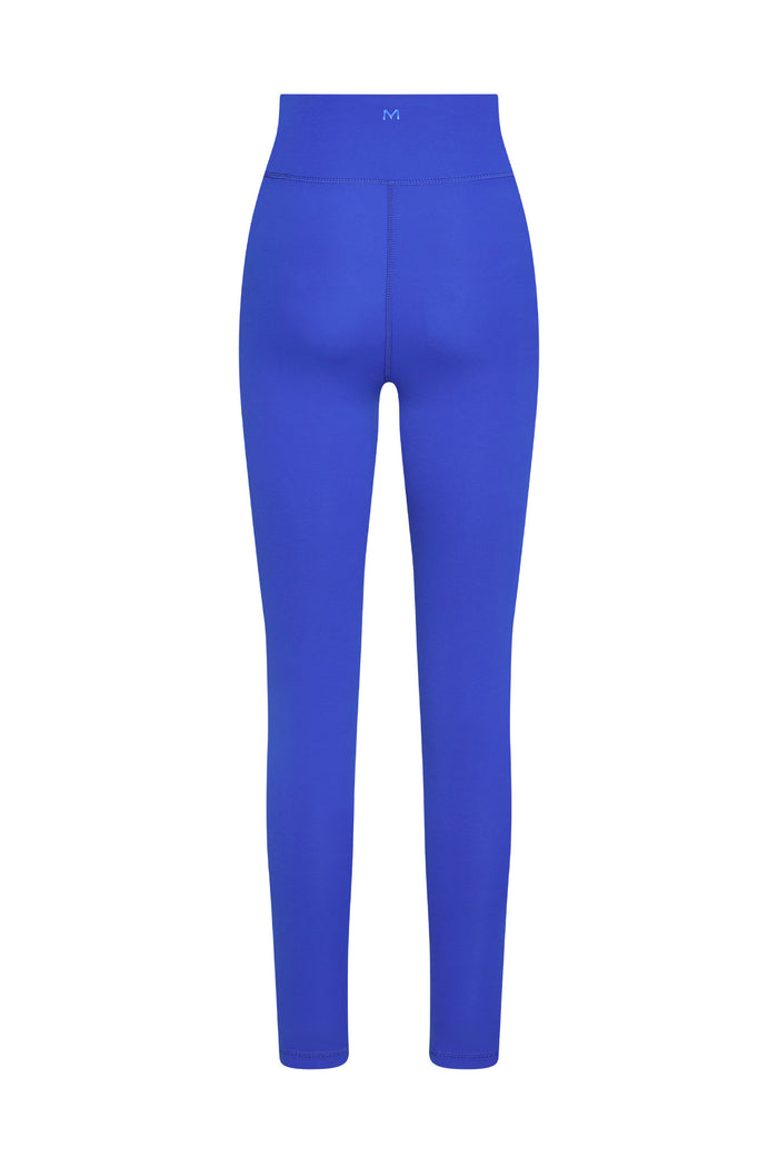 High-waist royal blue leggings, back view; small M logo centered on the waistband.