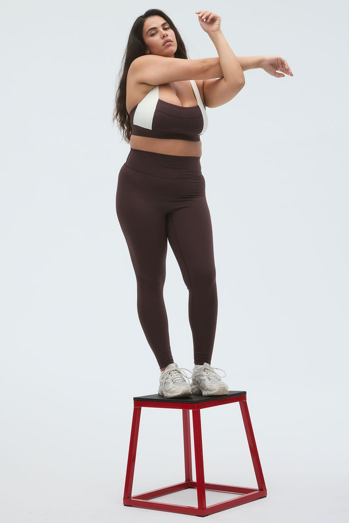 Front view of Acadia legging 27-inch in espresso on a plus-size model showing high waist and full-length fit