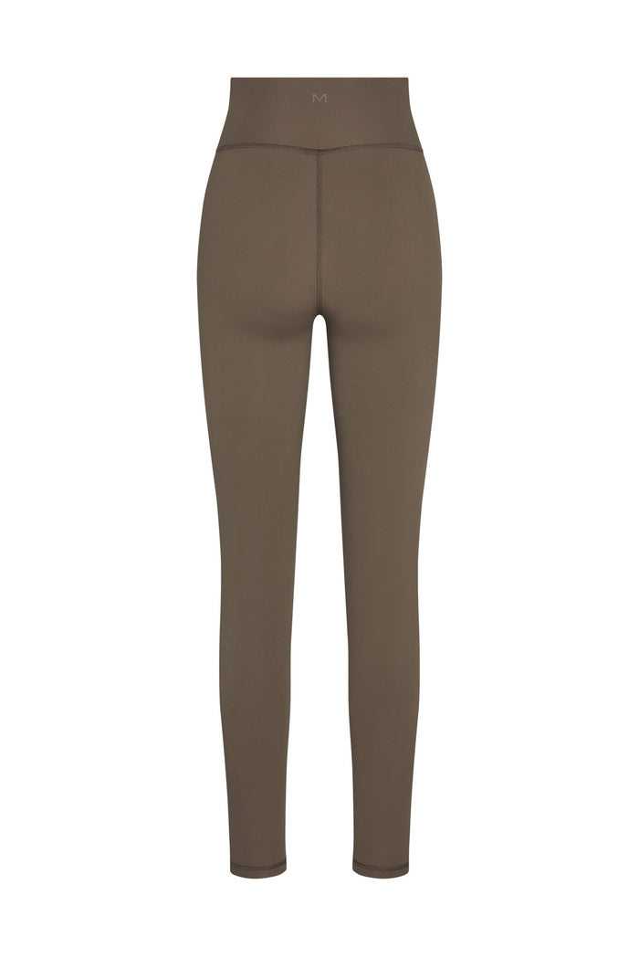 Back view of Acadia Legging in Stone Jersey showing high-rise waistband, center-back seam, ankle-length slim fit on white
