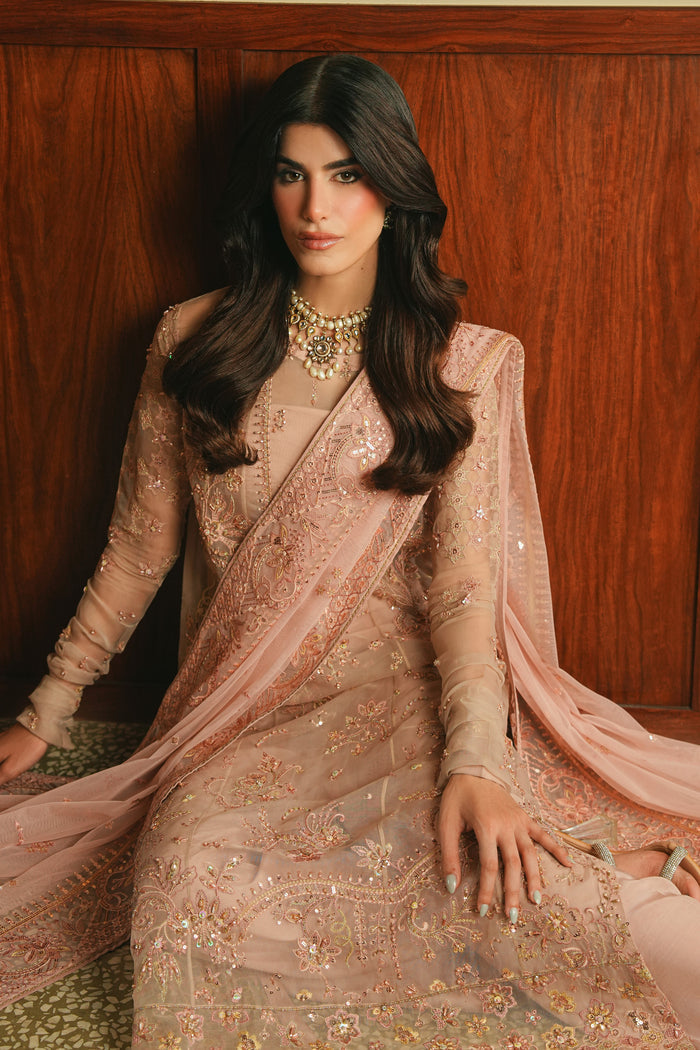 Seated view of NAQSHI Adiva Lalic Dream outfit highlighting soft fabric fall, detailed embroidery, and polished occasion wear style.