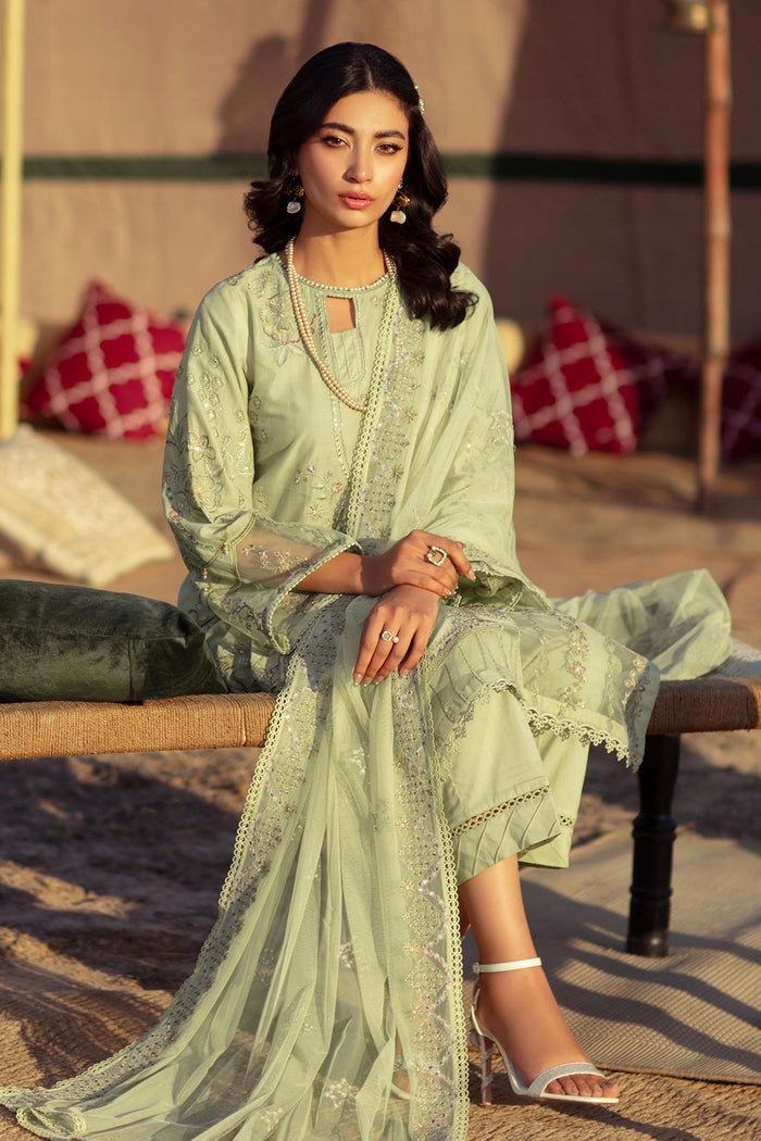 Seated pose of NAQSHI Aiza outfit showing flowing dupatta, embroidered details, and elegant festive styling