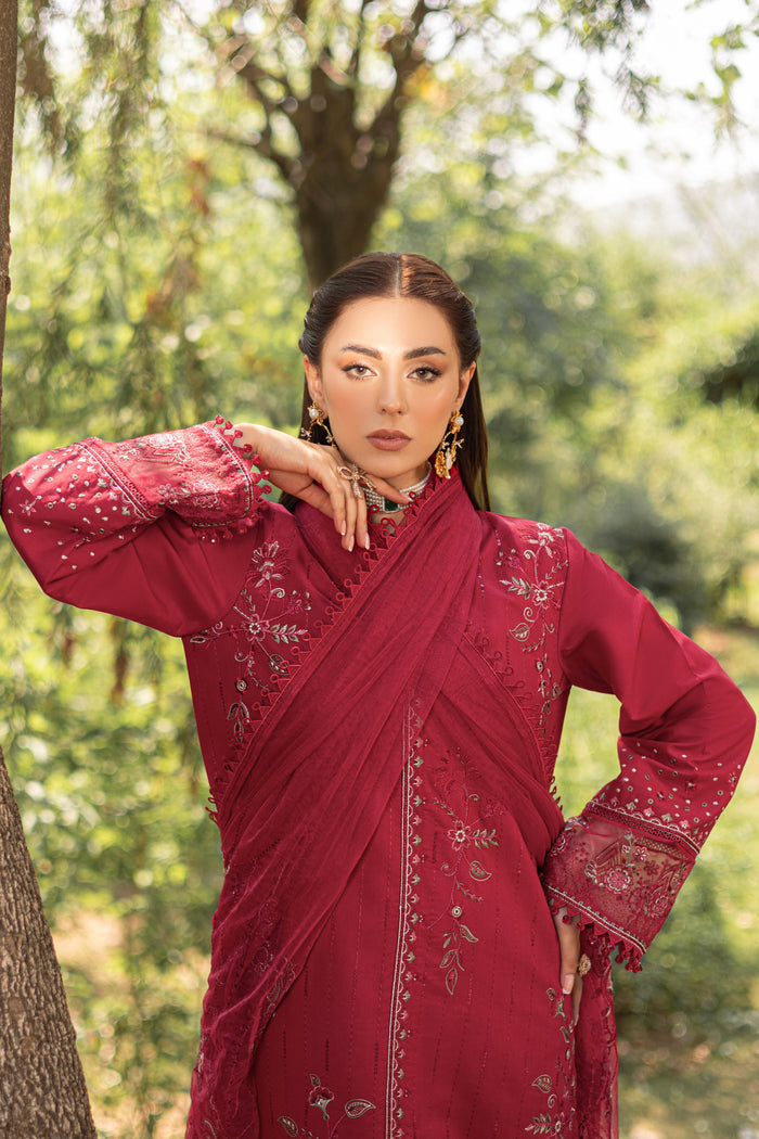 Three-quarter pose of NAQSHI garnet red outfit highlighting embroidered sleeves and detailed shirt fall