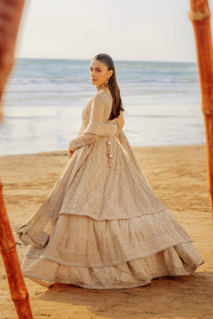 Rear view of NAQSHI Alara highlighting a back adorned with heavy handmade tassels, embroidered & sequin edged borders on frock layers.