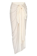 Cream wrap sarong tied at the waist with a long draped knot and cascading front panel