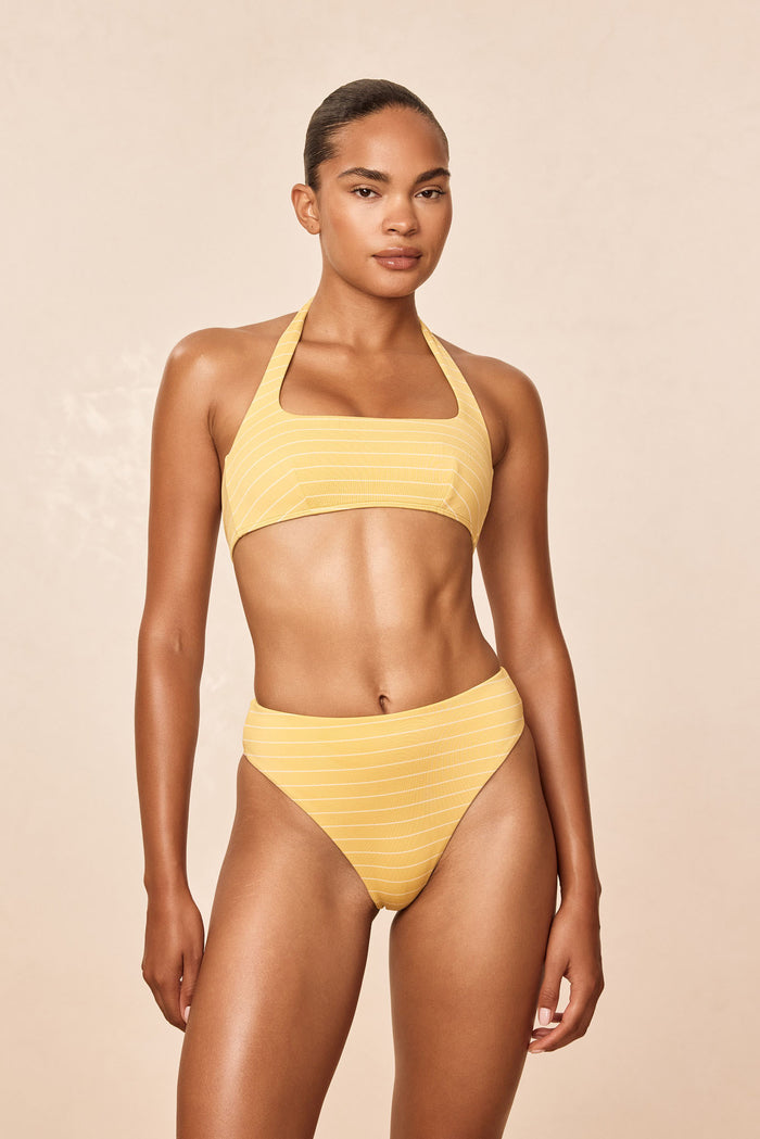 Front view of Amalfi Top Meyer Stripe showcasing square neckline and adjustable halter neck on model with beige background