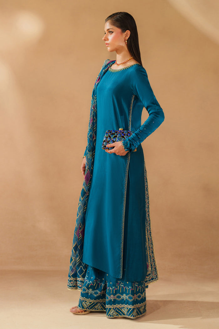 Styled pose of NAQSHI Anaiza zinc luxury pret outfit showing smooth fabric fall, refined embroidery details, and event-ready elegance
