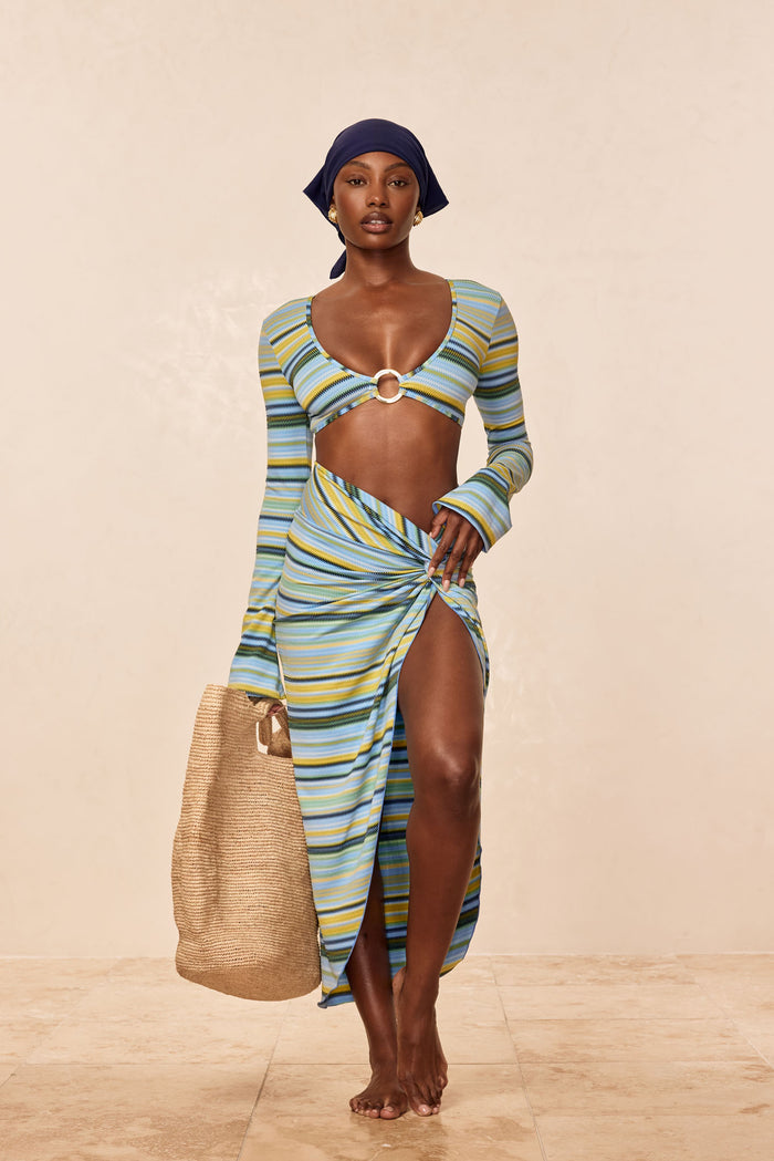 Front view of Andros Sarong in Sardinia Stripe Azure showcasing knotted waist and high thigh slit on a beige studio background