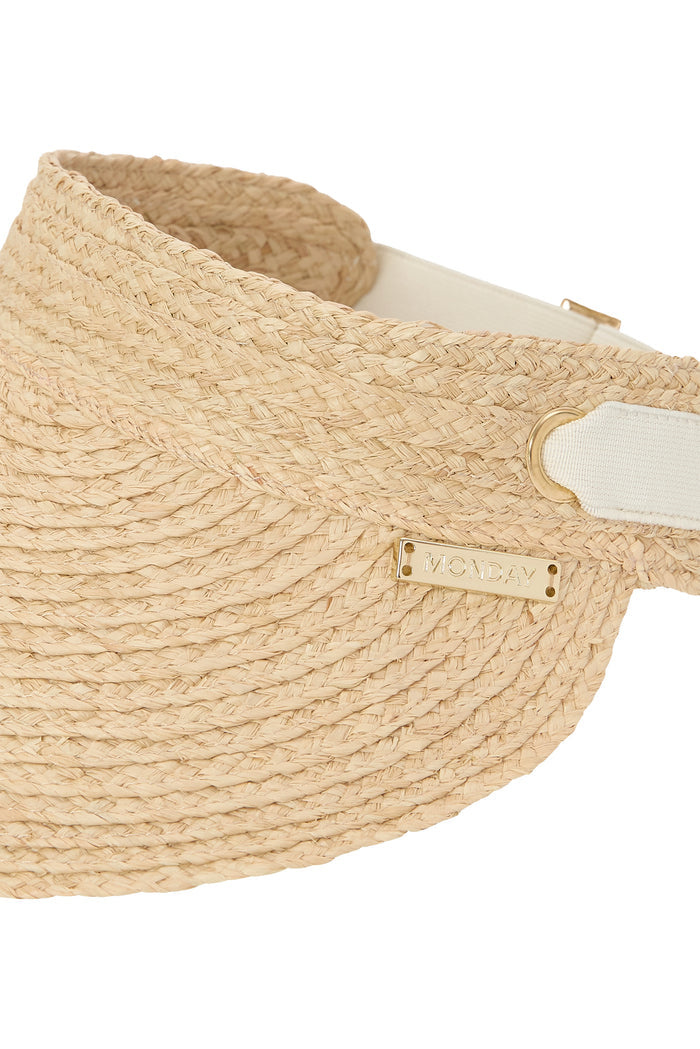 Close-up of Anguilla Visor in natural raffia showing woven rounded brim, padded forehead lining, adjustable elastic back band, and gold MONDAY logo on white background
