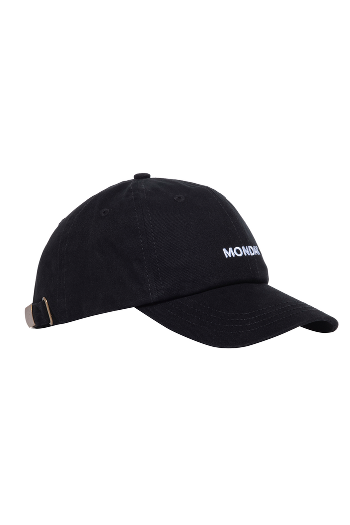 Black cotton baseball cap with white embroidered 'MONDAY' on the front and adjustable metal-clip strap.