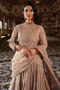 Model wearing full Naqshi Areeza bridal set: skin‑gold embellished choli, voluminous lehanga & ornate dupatta styled for bridal grace.