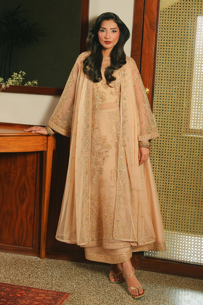 Side walking view of NAQSHI Arish peach fuzz outfit showing smooth culotte movement, structured shirt fit, and graceful event-ready look.