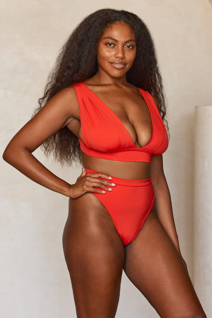 Front view of Aruba Top in Chili Pepper showcasing deep V over-the-shoulder neckline, pleated cups and supportive underband with neutral background