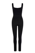 Front view of Aspen Catsuit in black jersey showcasing square neckline, high waist seam and full-length tapered legs on white background