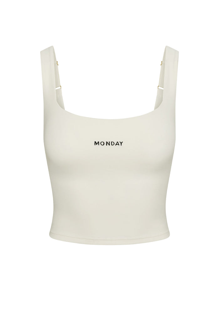 Front view of Aspen Tank in ivory showcasing square neckline, shelf bra, cropped length and MONDAY logo on white background