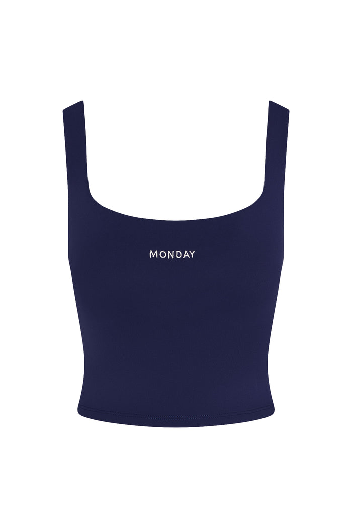 Front view of Aspen Tank in midnight jersey showcasing square neckline, fitted silhouette and MONDAY logo on white background