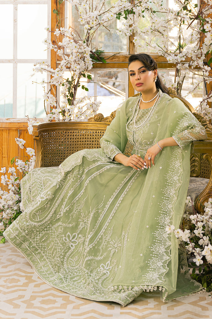 Seated styling view of Ayla formal dress highlighting wide flare and embroidered detailing, elegant ready to wear occasion wear.