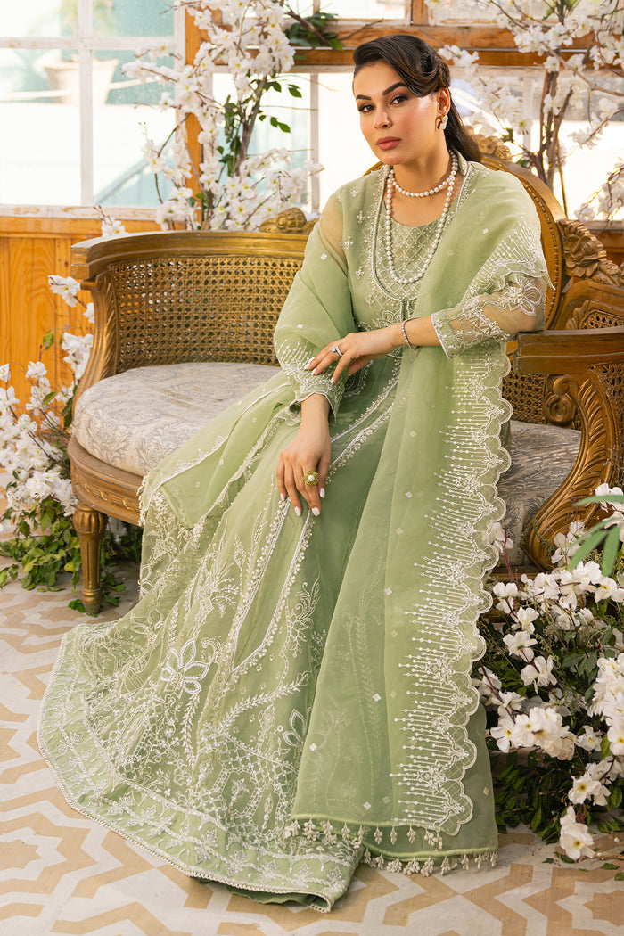 Seated side portrait of Ayla pistachio outfit showing soft layered fall and coordinated styling, traditional ready made festive attire.