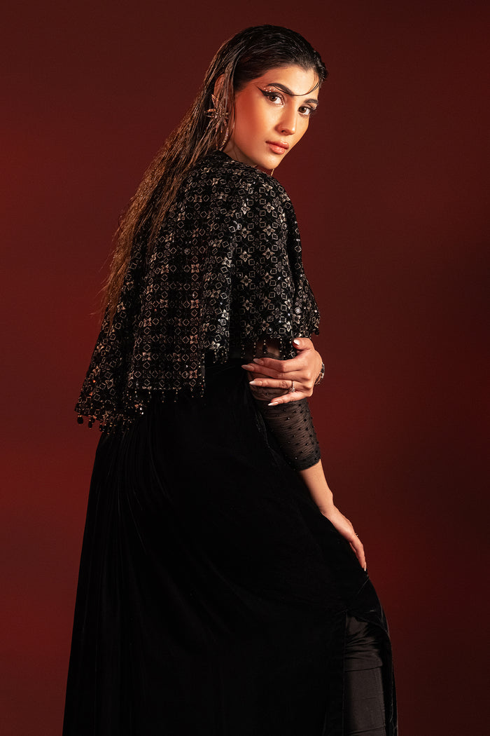 Back styling pose of Ayna outfit highlighting embroidered cape layer and tassel detailing, ready to wear evening formal attire.