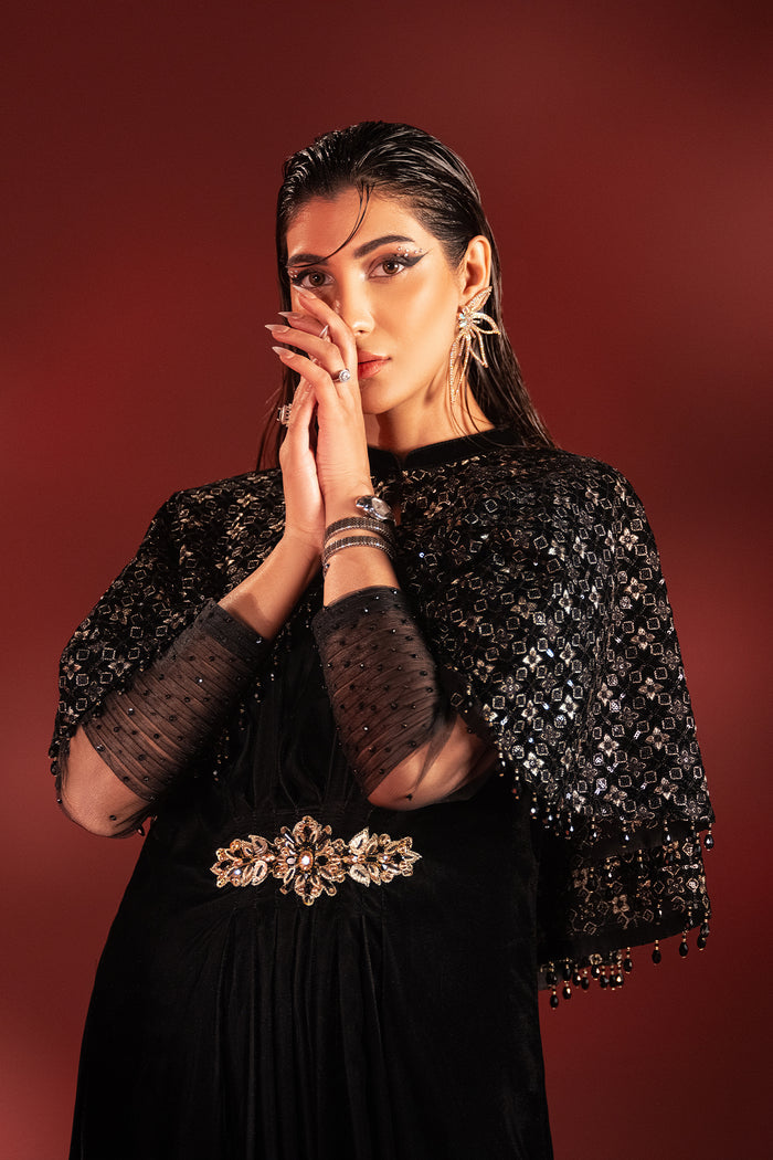 Close up portrait of Ayna black velvet dress highlighting net sleeves pleats and sitari work, ready to wear party outfit.