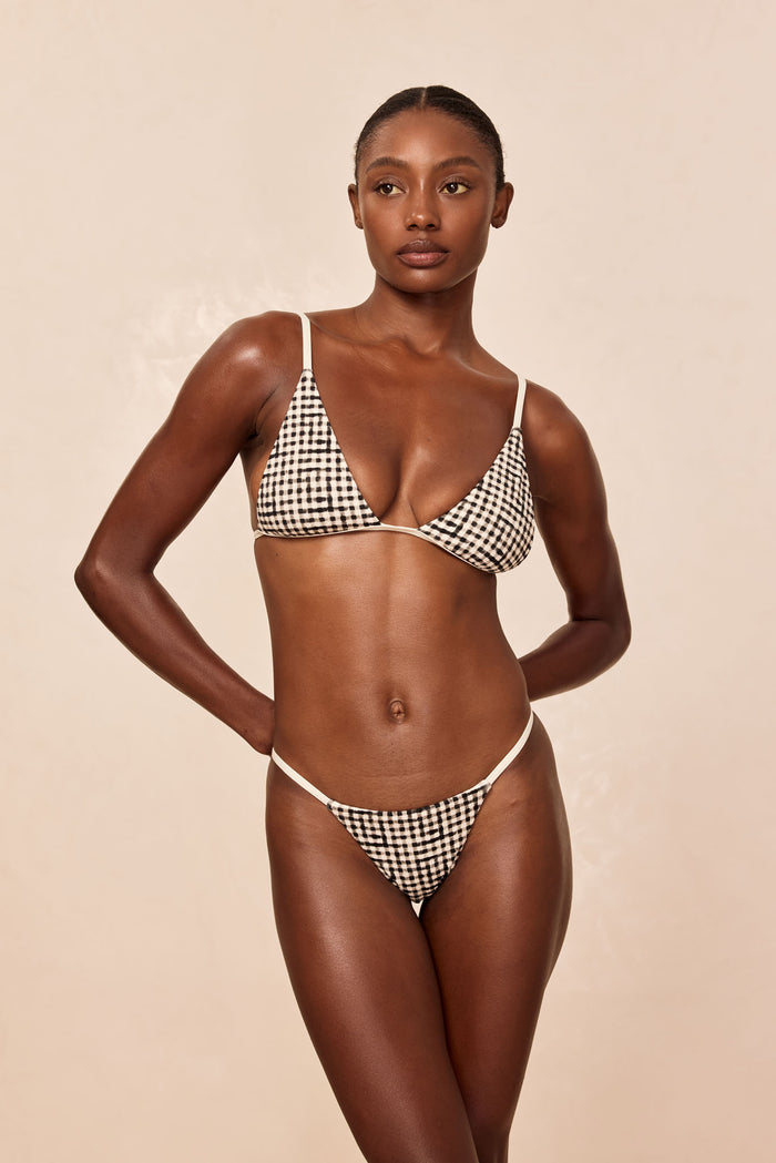 Front view of Barbados Bottom in Black Gingham showcasing high-cut leg, thin side straps and minimal coverage on beige background