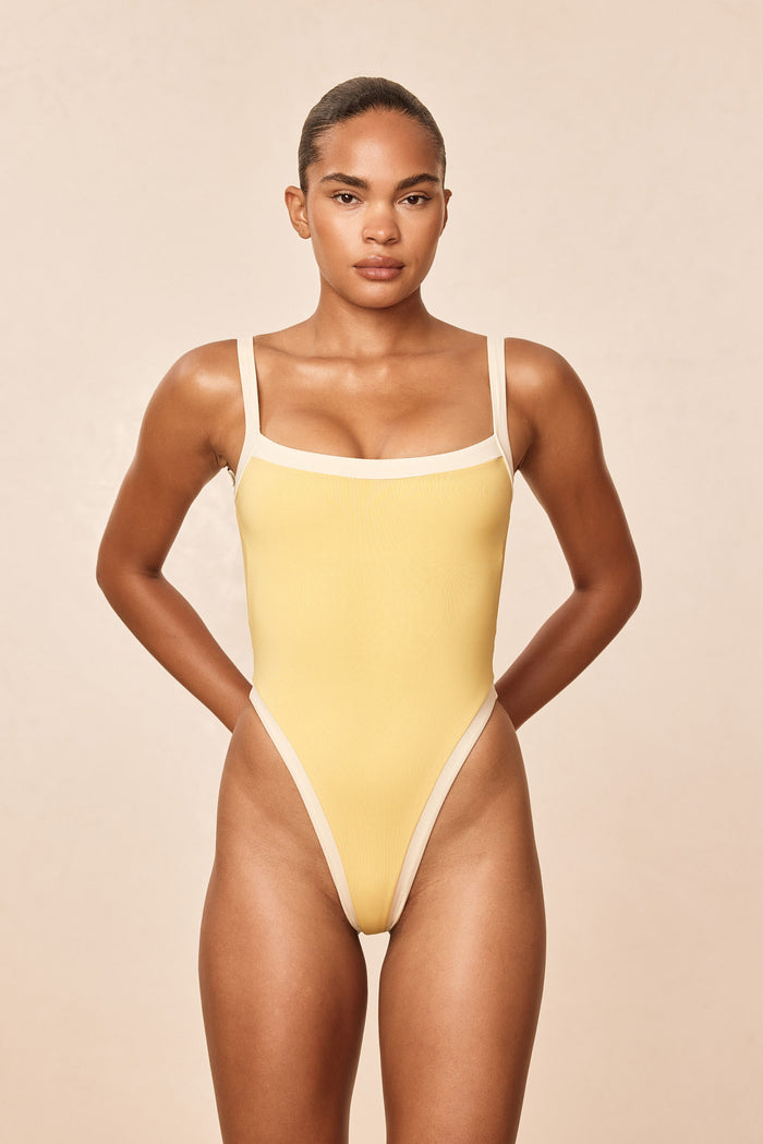 Front of Barcelona One Piece Meyer/Ivory with high-leg cut, shelf bra and adjustable straps on neutral background