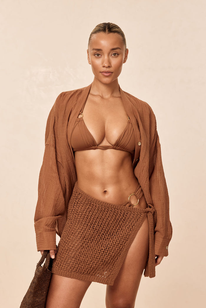 Front view of Barcelona Tunic in caramel crinkle linen showcasing oversized fit, seashell buttons, flowy sleeves and side slits on a neutral background