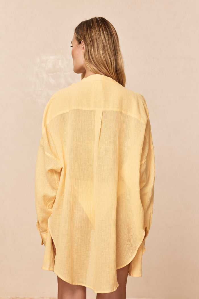 Back of Barcelona Tunic in Honey Crinkle on model, oversized fit, sheer crinkle fabric with back pleat, neutral background