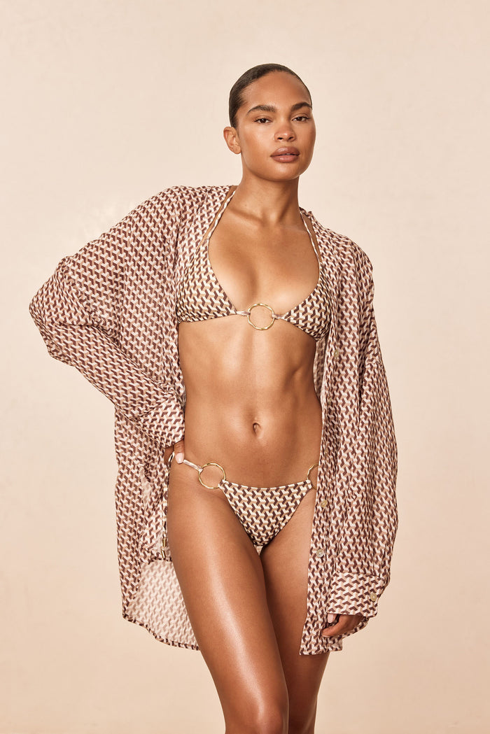 Front view of Barcelona Tunic in Husk Geo crinkle linen, relaxed fit on model with long sleeves against beige background