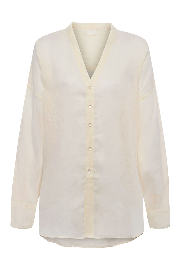 Front view of Barcelona Tunic in ivory linen showcasing V-neck, seashell buttons and long sleeves on white background