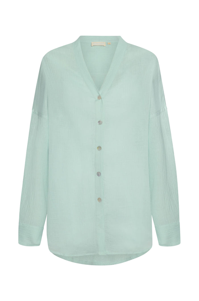 Front view of Barcelona Tunic in light slate crinkle linen showcasing V-neck, button-front and relaxed fit on white background