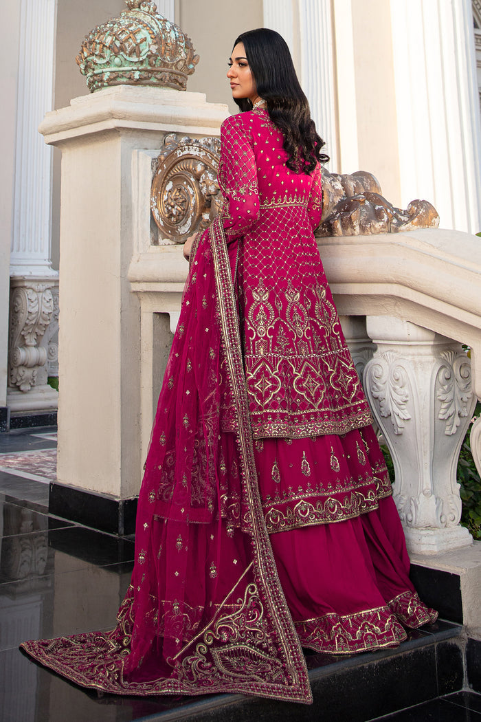 Side shot of Behnaam showing frock’s layered cut, center front slit, cascading embroidery on georgette fabric, and raw‑silk lehenga flare beneath.