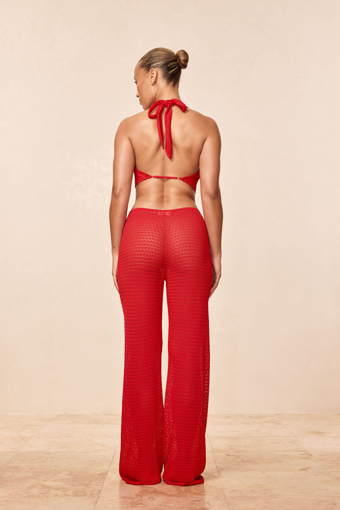 Back view of Belize Knit Pant in Chili Pepper showing sheer open knit texture and drawstring waist on neutral background