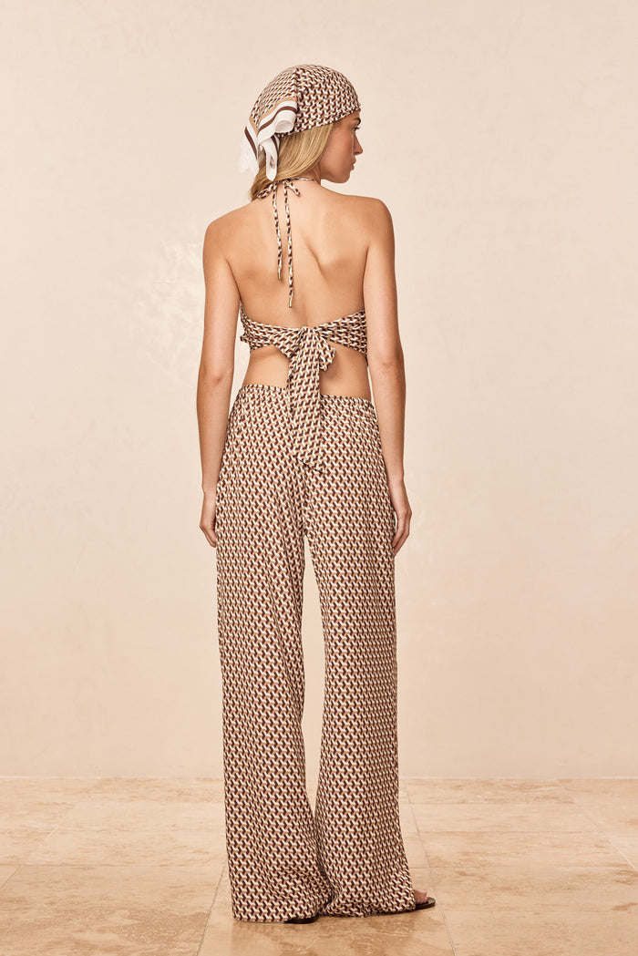 Back view of Belize pant in Husk Geo Silk showing wide-leg geo-print pants and matching tie-back top on beige background