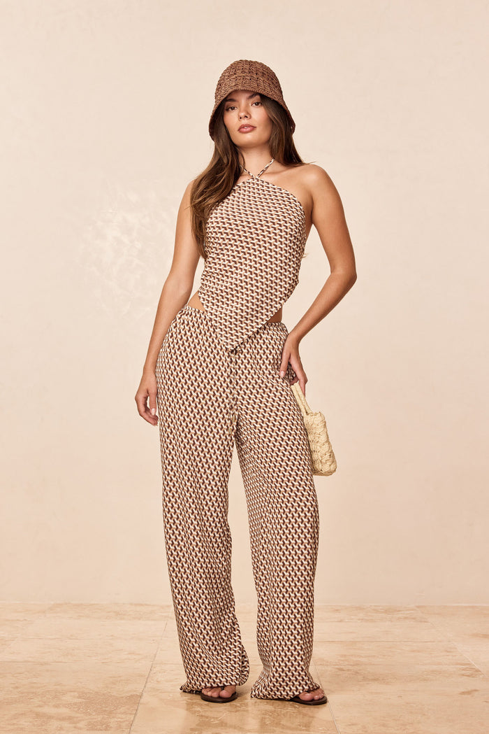 Front view of Belize Pant showing high-rise adjustable drawstring waist, side cutout and wide-leg fit on beige studio background
