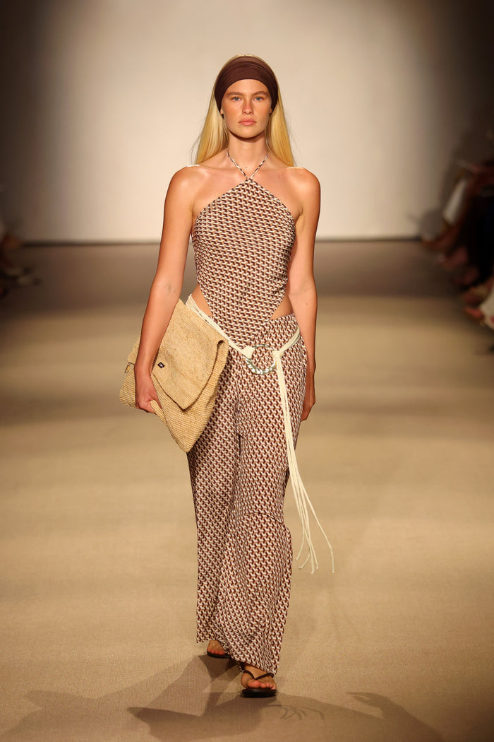 Front view of Prato Top showcasing halter neckline and brown-and-cream geometric print on runway