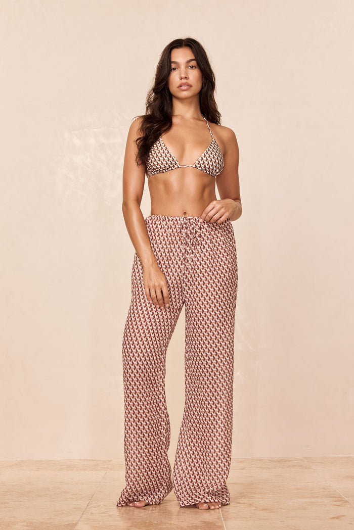 Front view of Belize Pant in Husk Geo showcasing drawstring elastic waist and wide-leg fit on model against a beige studio background