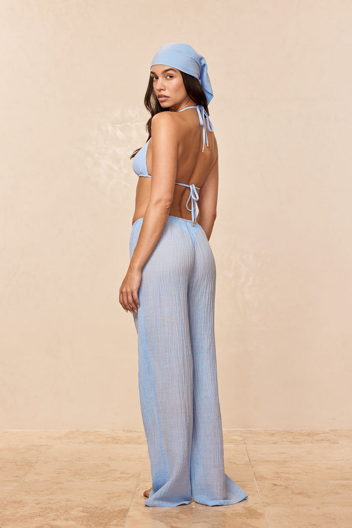 Rear view of Belize Pant in sky crinkle linen; wide-leg, crinkled texture and drawstring waist on neutral background