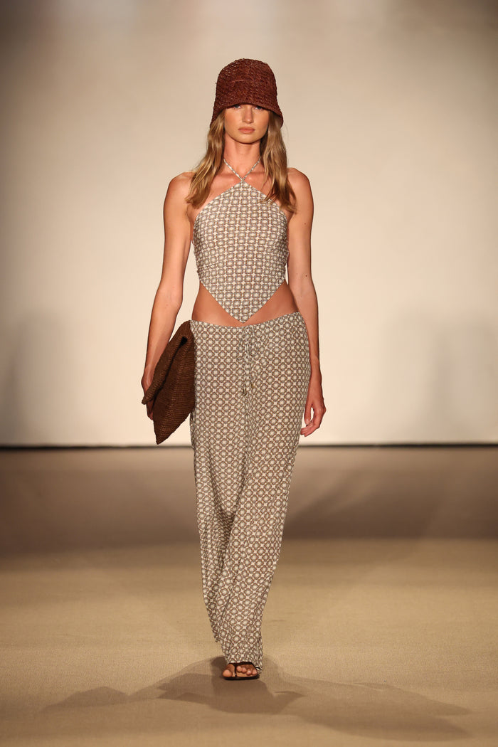 Front view of Belize Pant in Tile Geo silk showing low-rise drawstring relaxed wide-leg fit on model on neutral runway