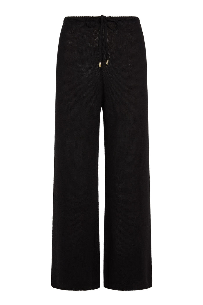 Front view of Belize Pant open-knit in black showing wide-leg silhouette and drawstring waist with gold aglets on white