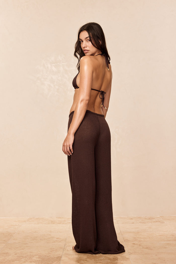 Rear three-quarter view of Belize Pant Open Knit in espresso showcasing wide-leg silhouette and textured knit on beige studio background