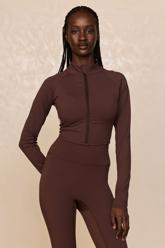 Front view of Big Sur Jacket in Espresso, cropped with center zipper, mock neck and tonal MONDAY embroidery on sleeve