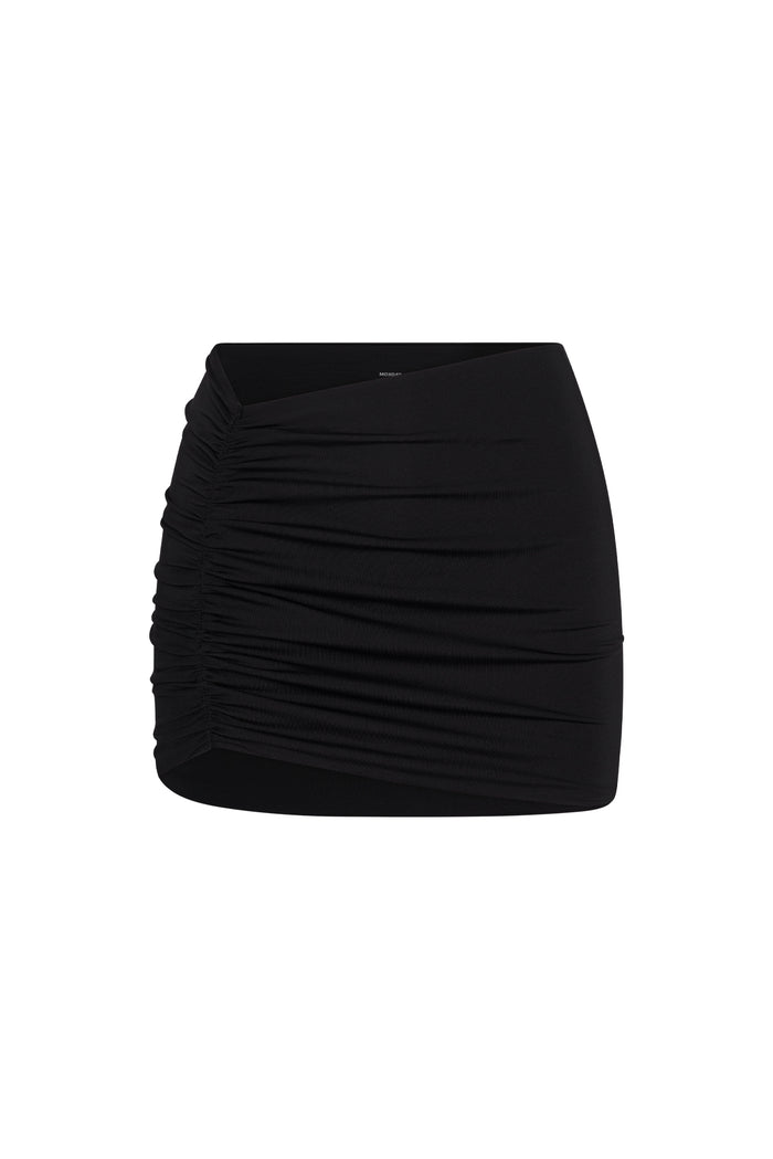 Cropped front view of Bimini mini skirt in black showcasing side ruching and low-to-mid rise on white background