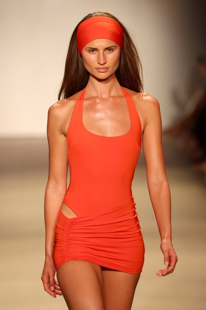 Front view of Bimini Skirt in Chili Pepper on model showing side ruching and low-to-mid rise on runway