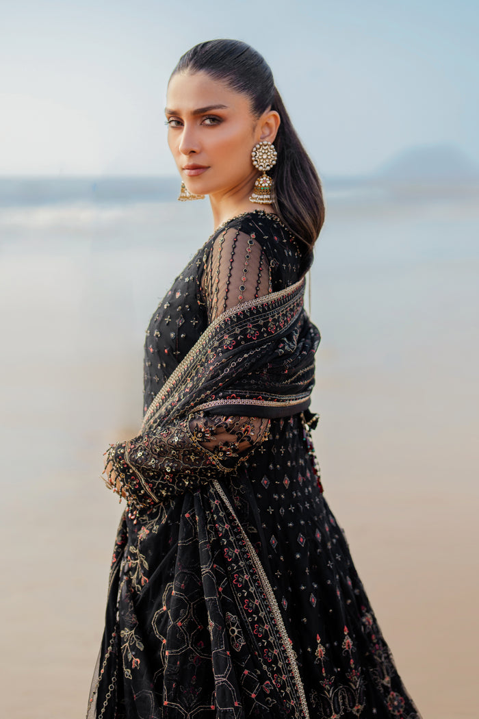 Back view of NAQSHI Blain frock featuring heavy handmade tassels hanging from back, embroidered red‑hued geometric border, and minimal lace finish.