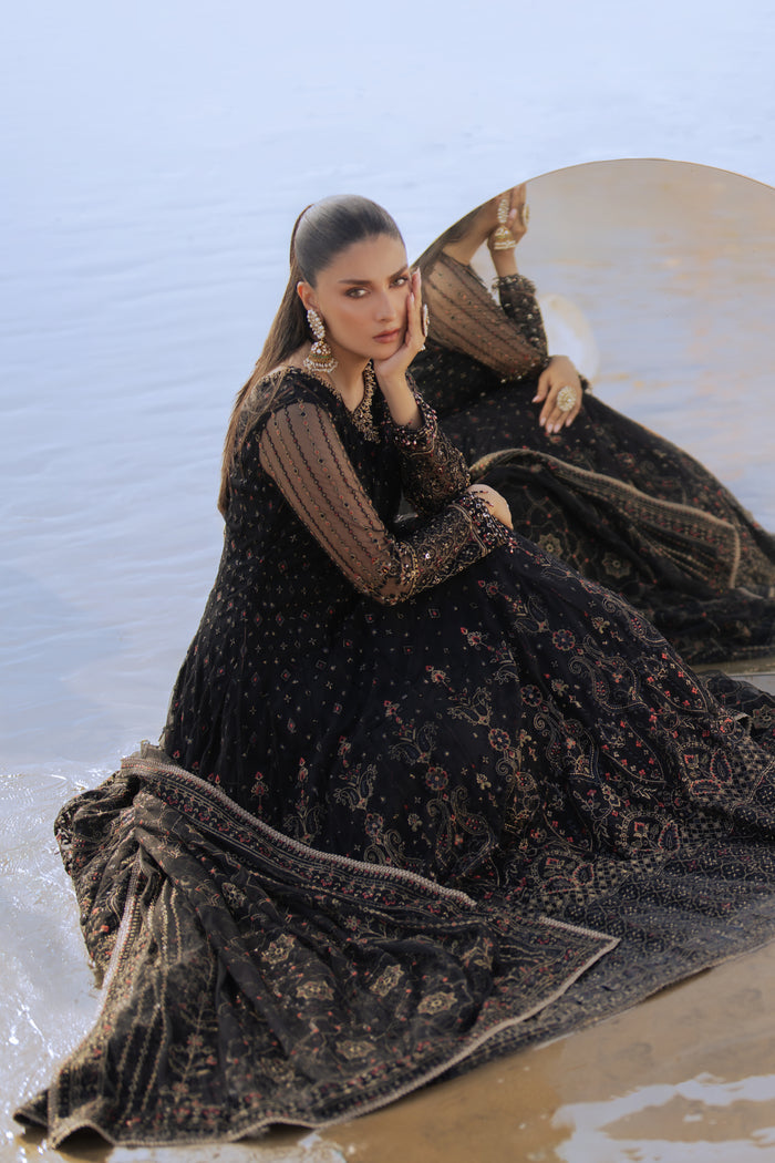 Model wearing full NAQSHI Blain set: black embellished net frock, plain straight PK raw‑silk pants, ornate dupatta with heavy embroidery & tassels.