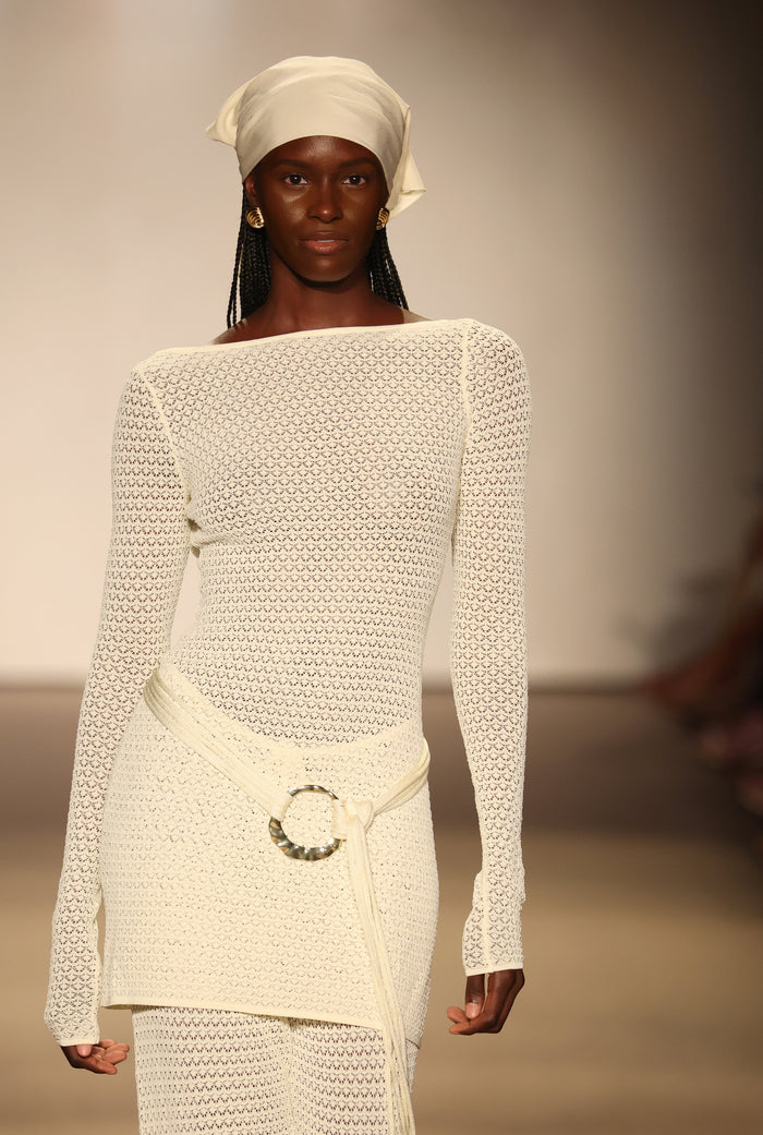 Front view of Bodrum Mini Dress in ivory lace crochet on model showing boat neckline, long sleeves, crochet texture and ring belt