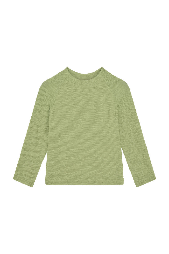Front view of Bondi Rashguard Kids in avocado crinkle showcasing long sleeves and textured crinkle fabric on white background